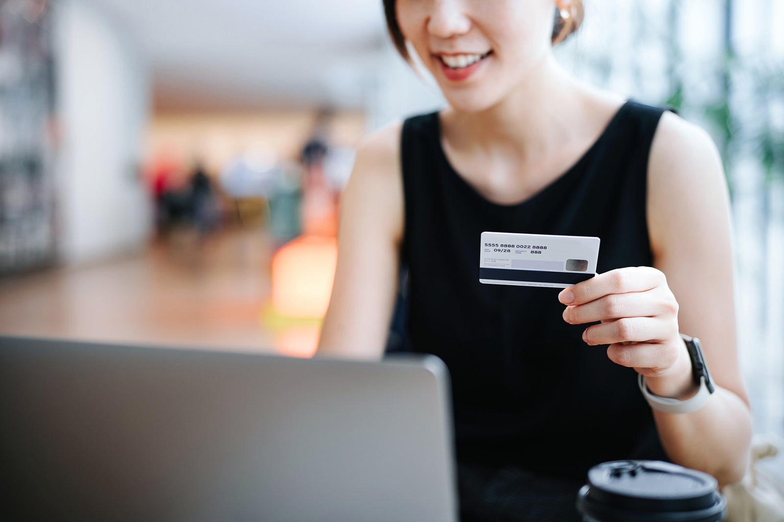 Woman paying with a credit card while shopping online