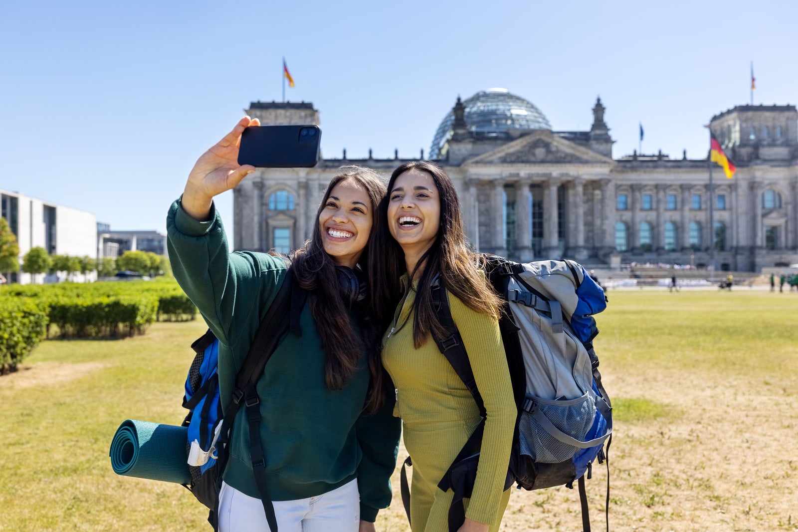 Women travelers taking selfie in front of the Reichstag building in Berlin