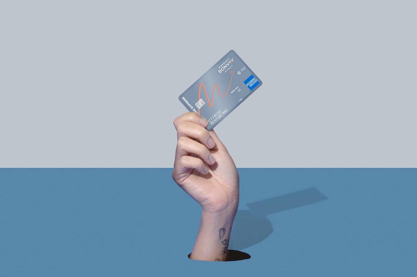 a hand holds a credit card