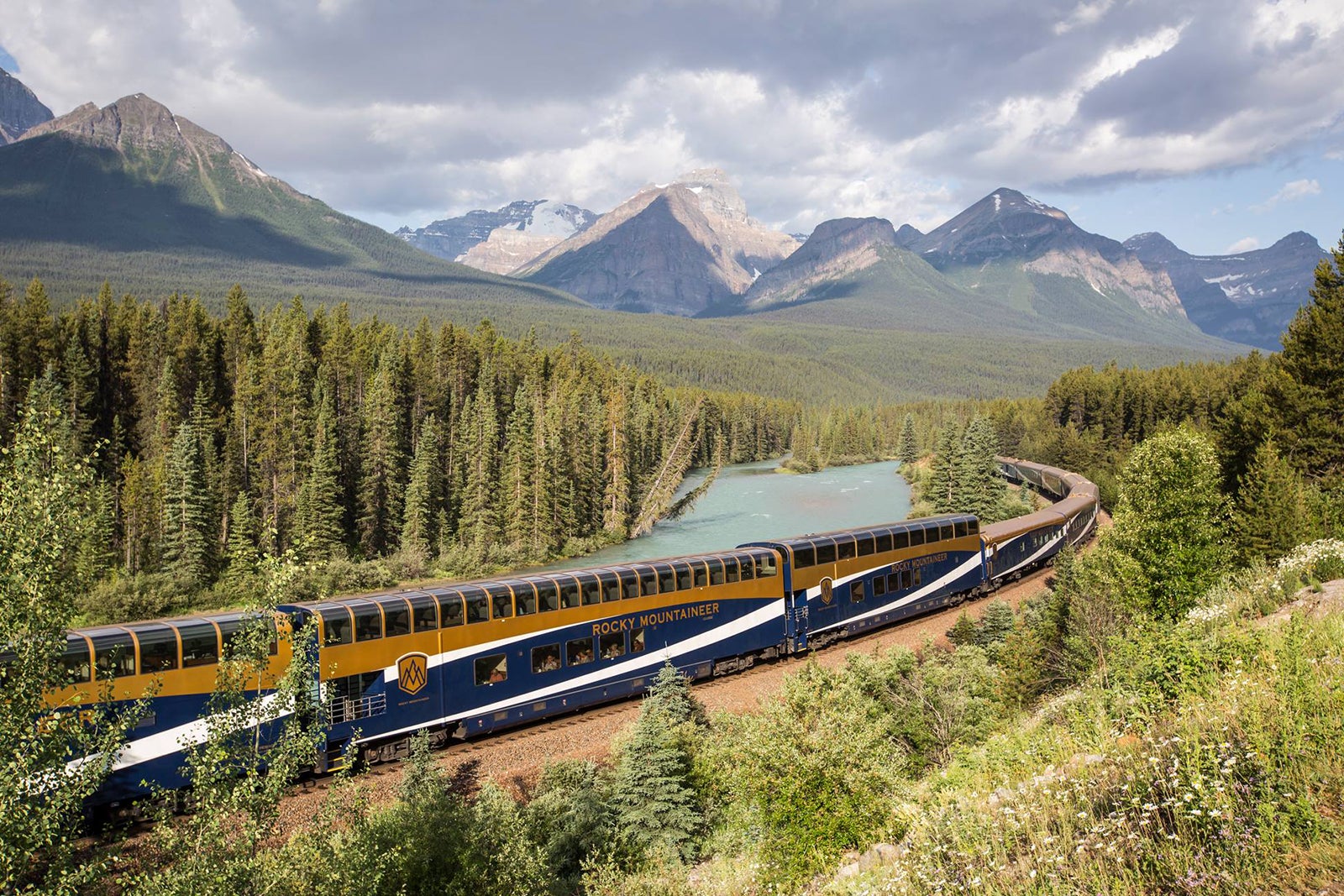 Rocky Mountaineer train winding through forests and mountains