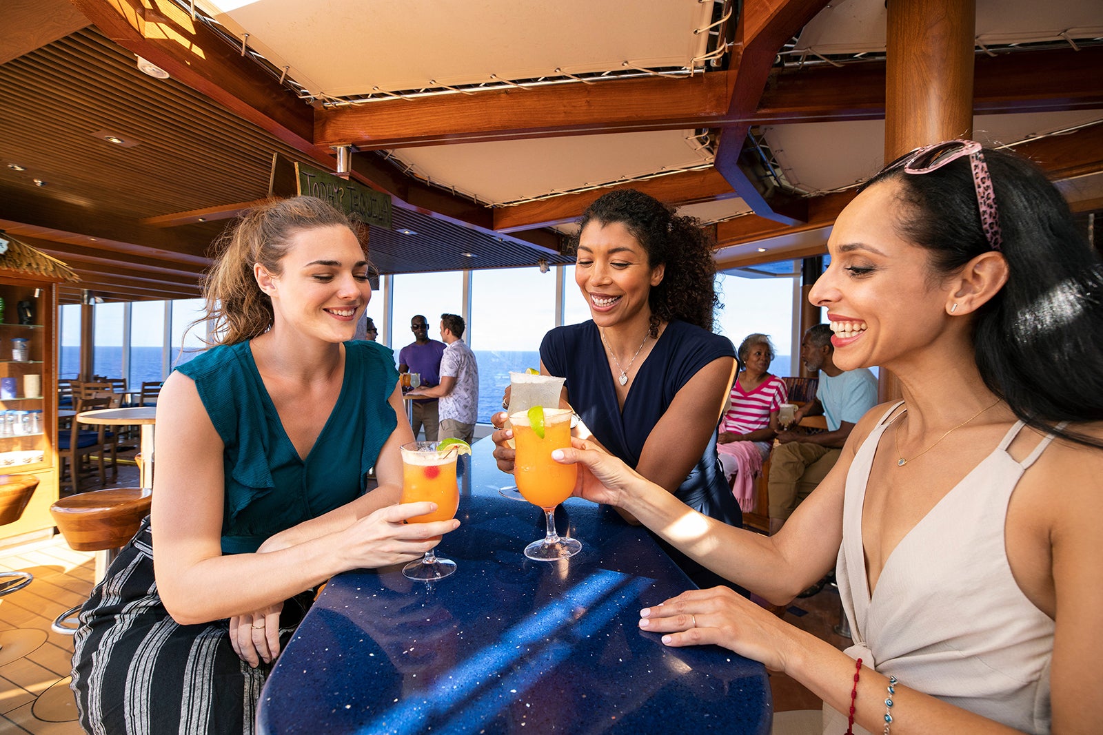 Three women having drinks at Carnival Cruise Line's Blue Iguana Tequila Bar