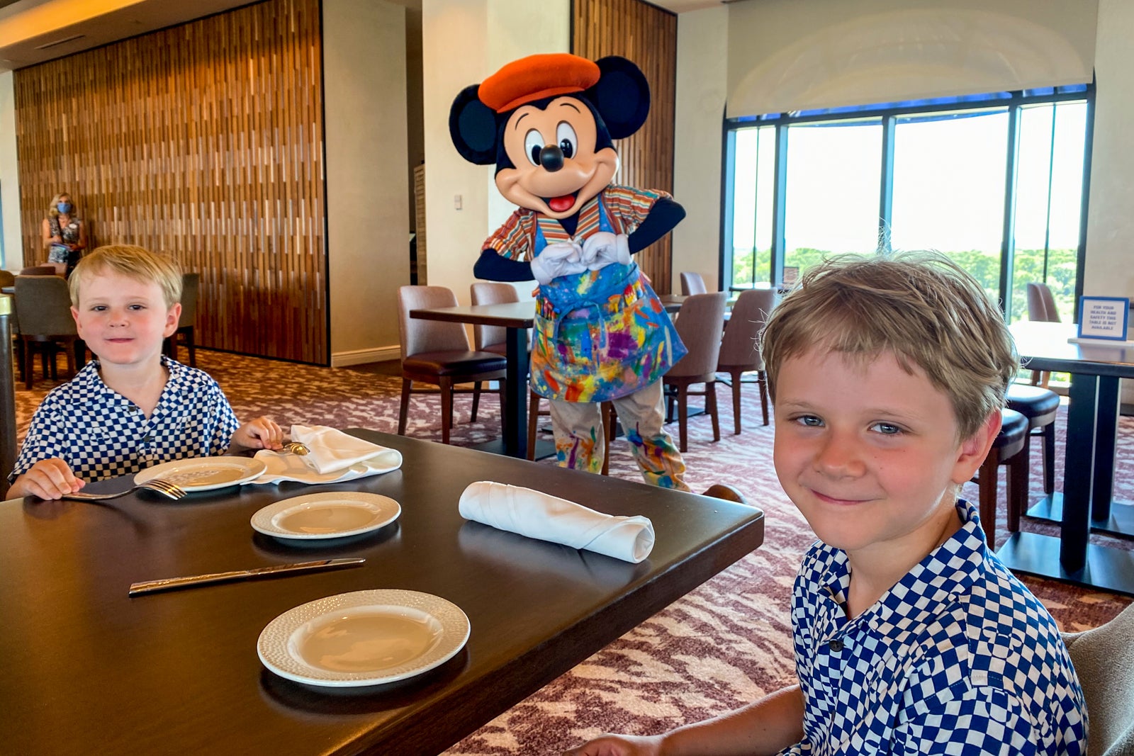 Brooke's kids posing with Mickey Mouse at Toppolini's Terrance at Disney World in Orlando