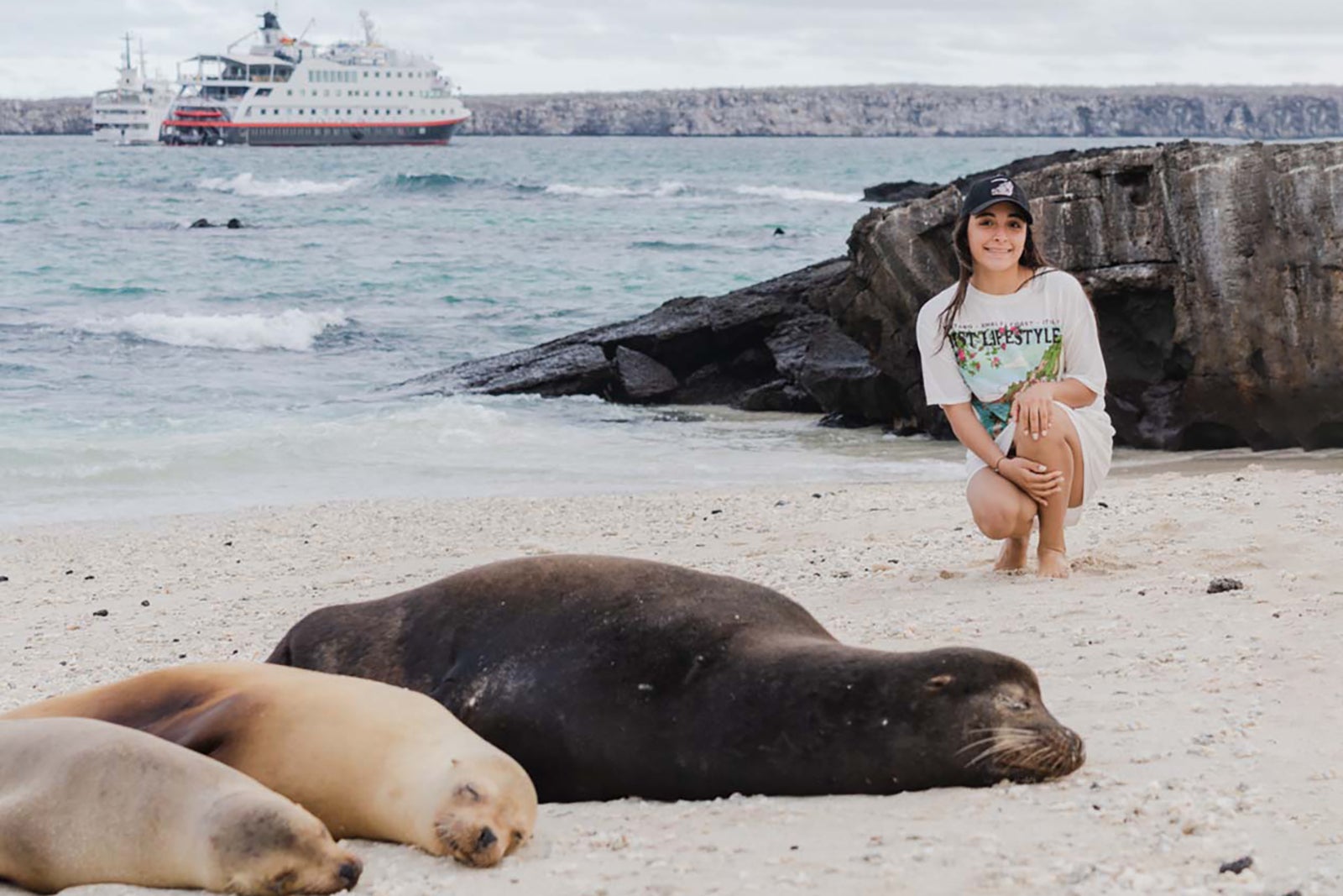 cruise passenger poses near sea lions