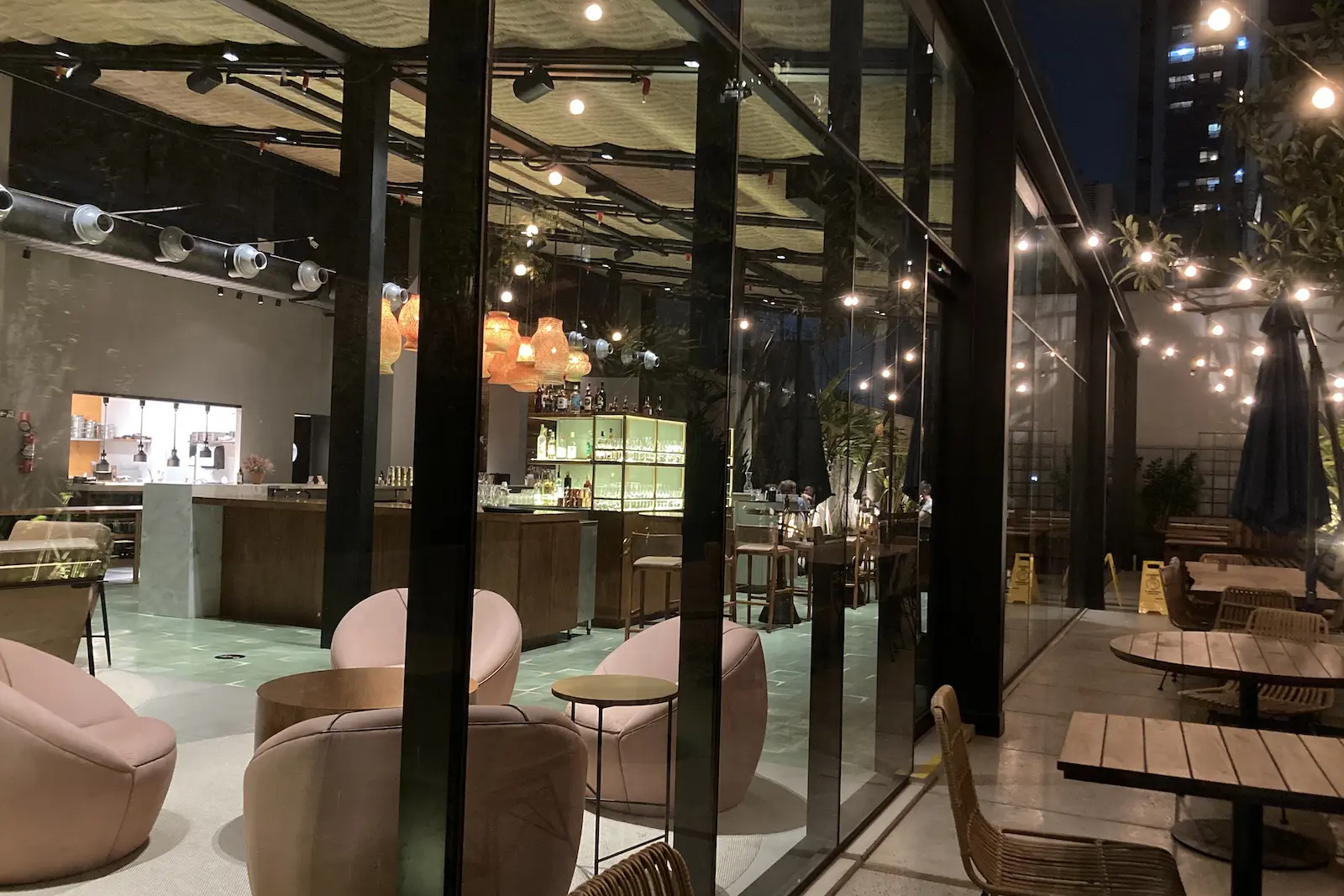 view from outdoor dining area through a window to the indoor dining area at a hotel
