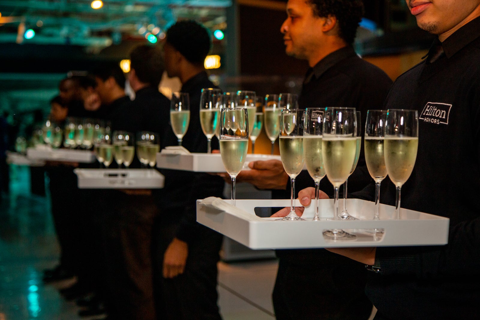 Waiters holding trays of champagne glasses at the TPG Awards in 2019.