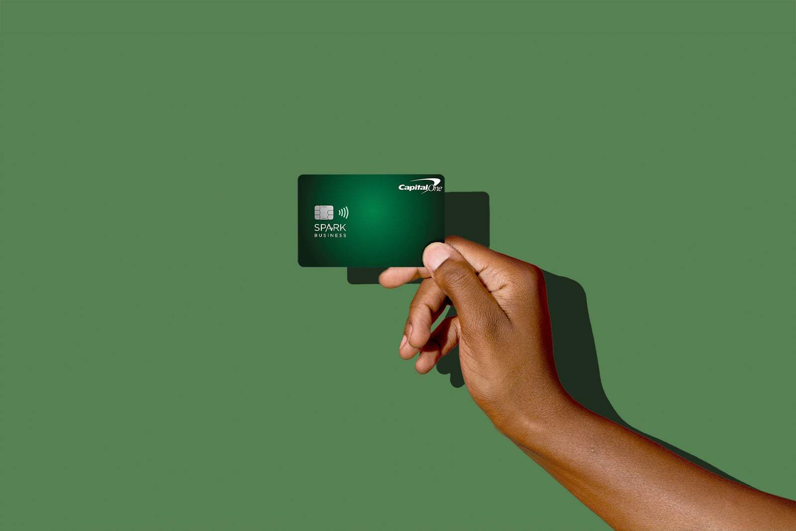 a hand holds a credit card