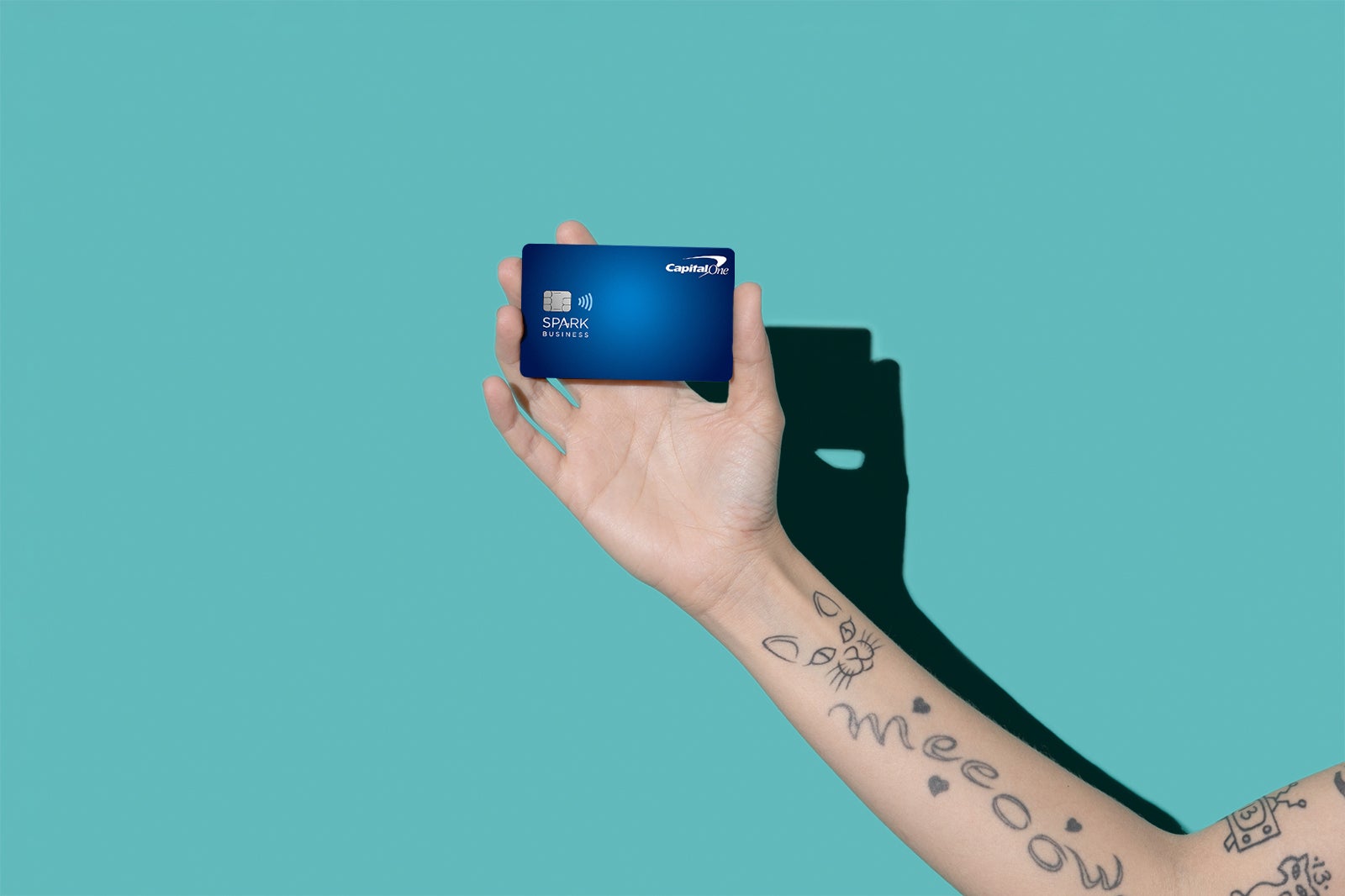 a hand holds a credit card