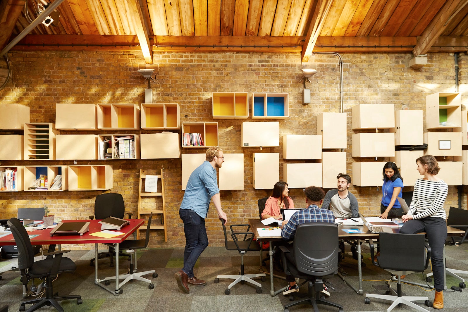 A team works on a project together around a conference table