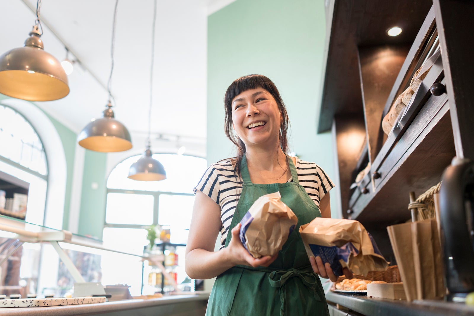 A smiling small business owner in a kitchen