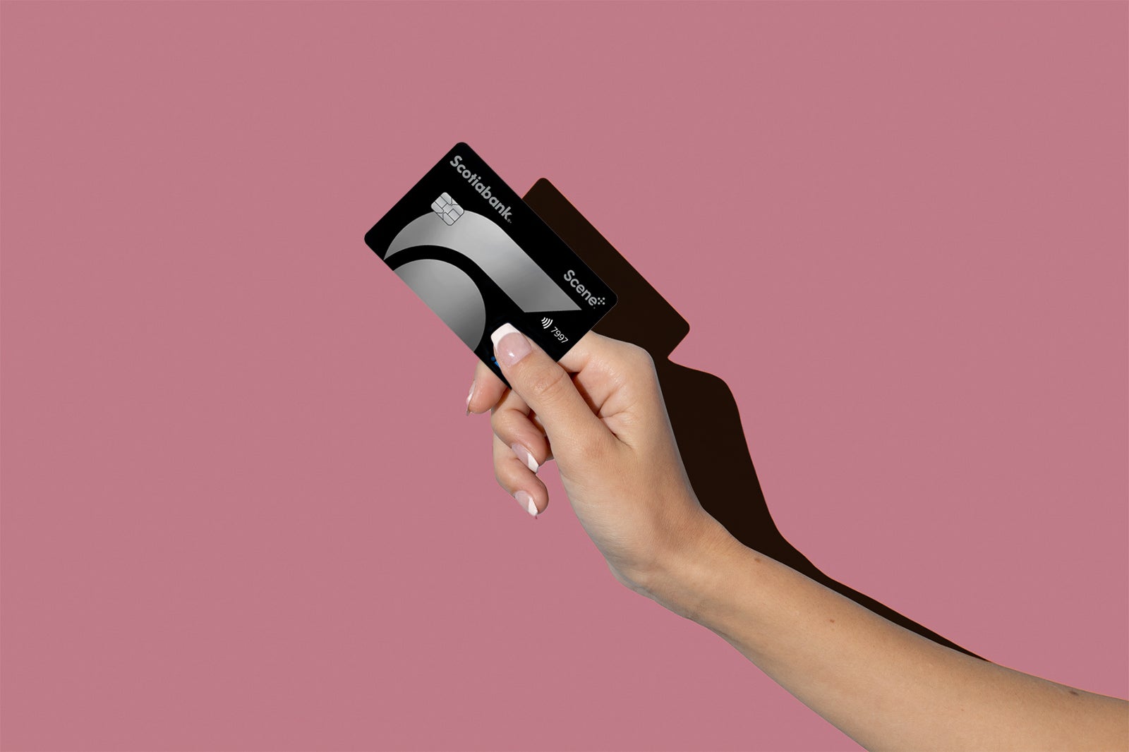 a hand holds one of the best travel credit cards in Canada
