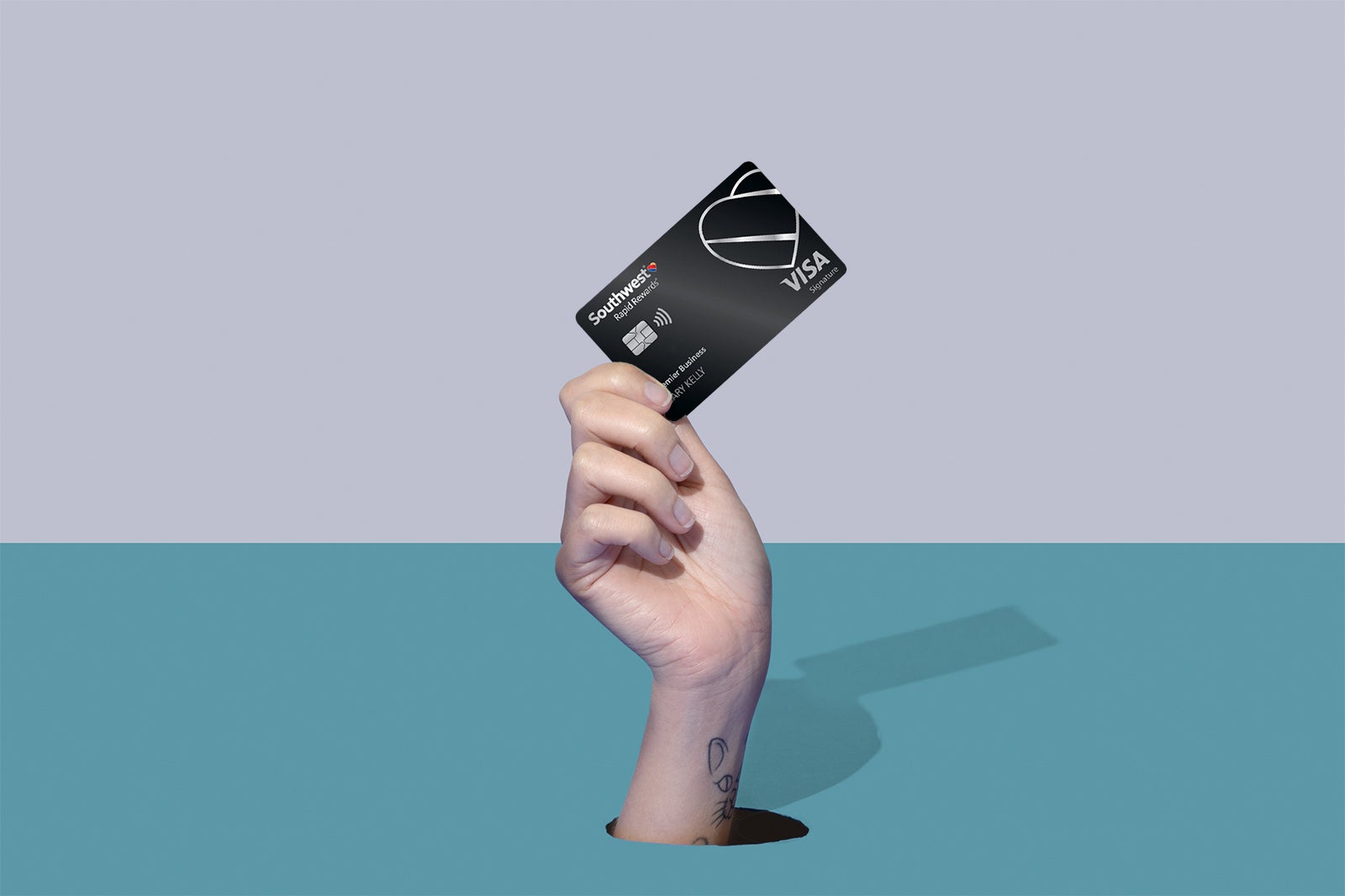 a hand holds a credit card