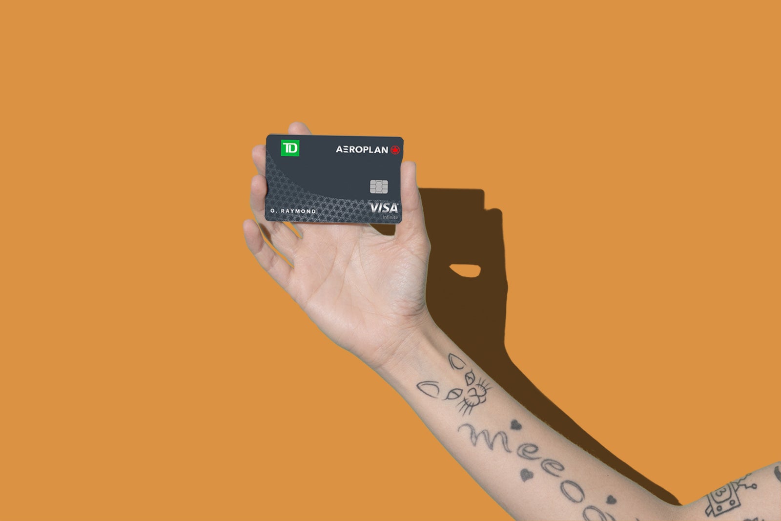 a hand holds a credit card