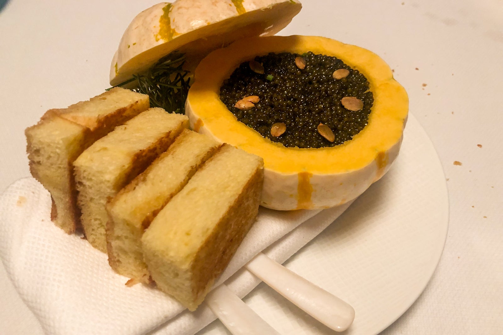 Kaluga caviar in a small white pumpkin with toasted brioche bread.