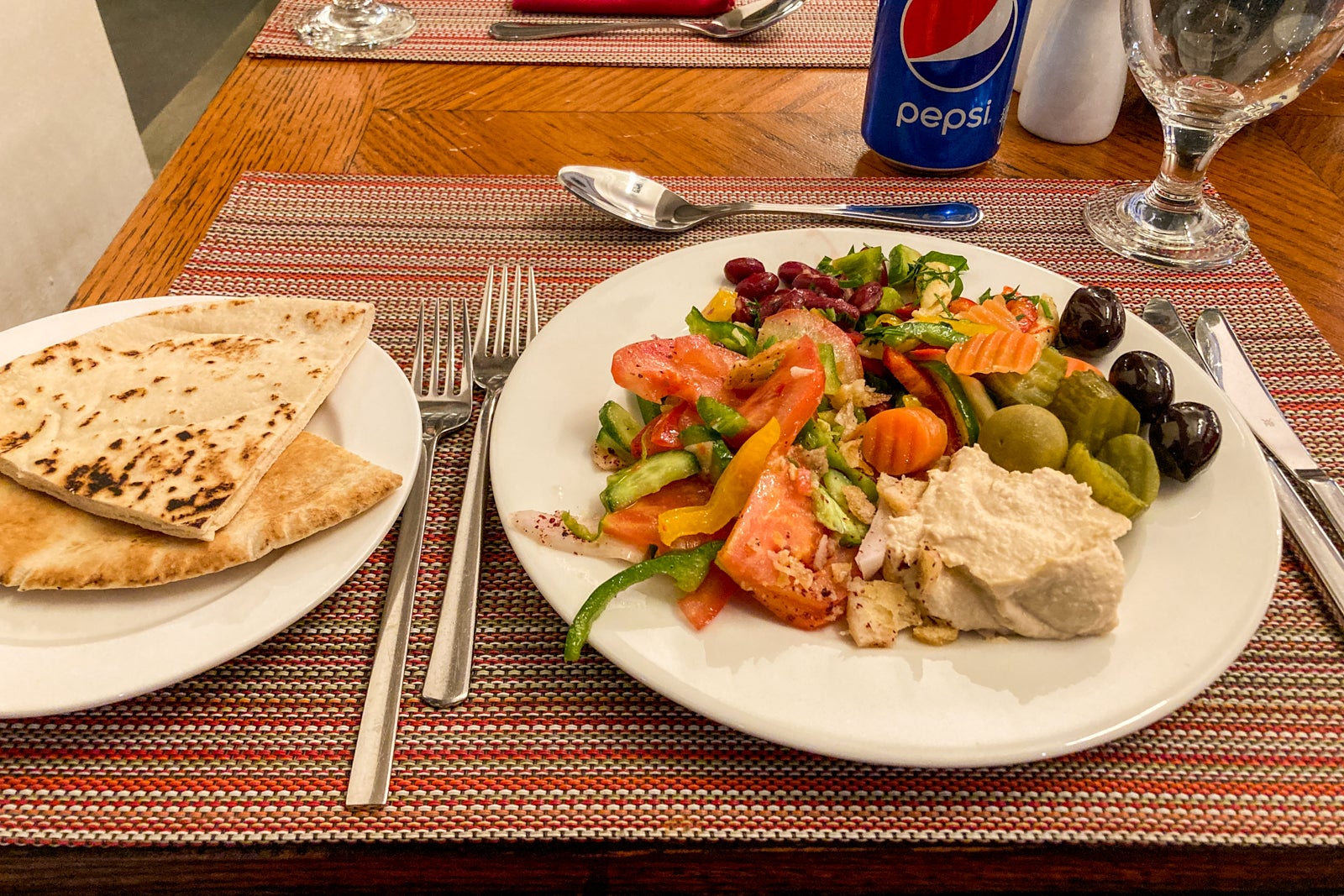 Middle Eastern food on an overflowing dinner plate, showing an array of colors and dishes