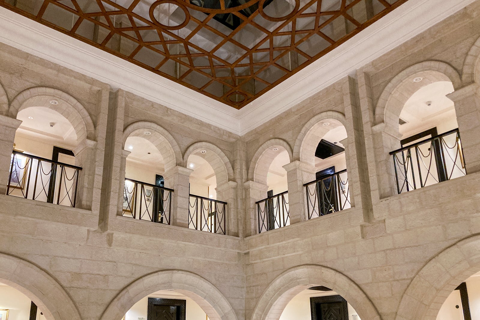 looking up at open hallways from a courtyard inside a hotel