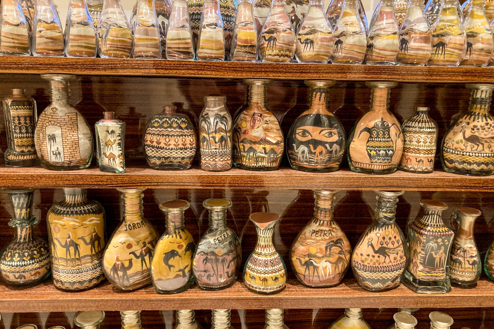 intricately decorated sand art in glass bottles