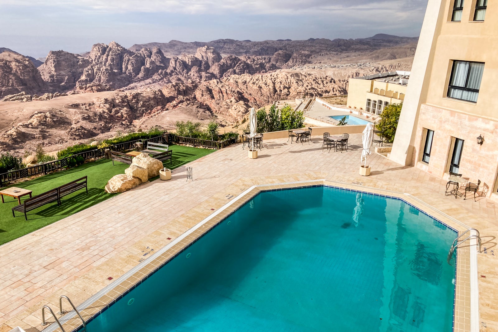 a swimming pool at a hotel in the desert, as seen from above