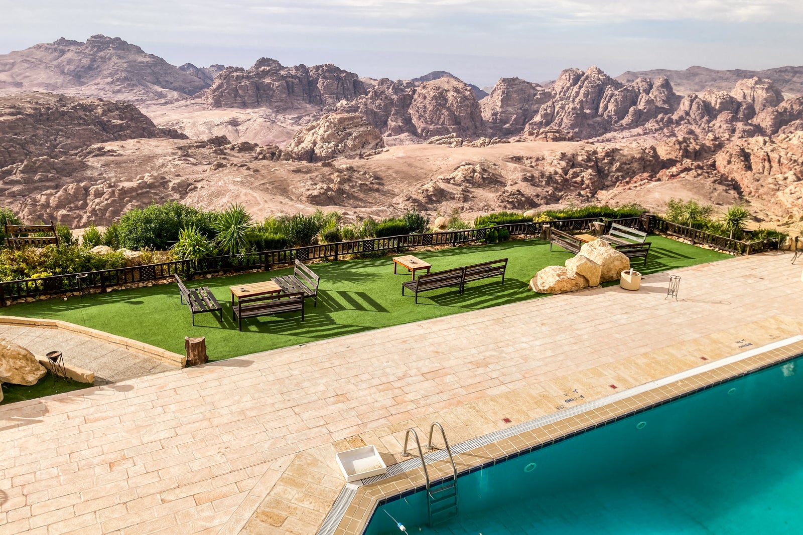 an outdoor deck with seating and a pool at a hotel