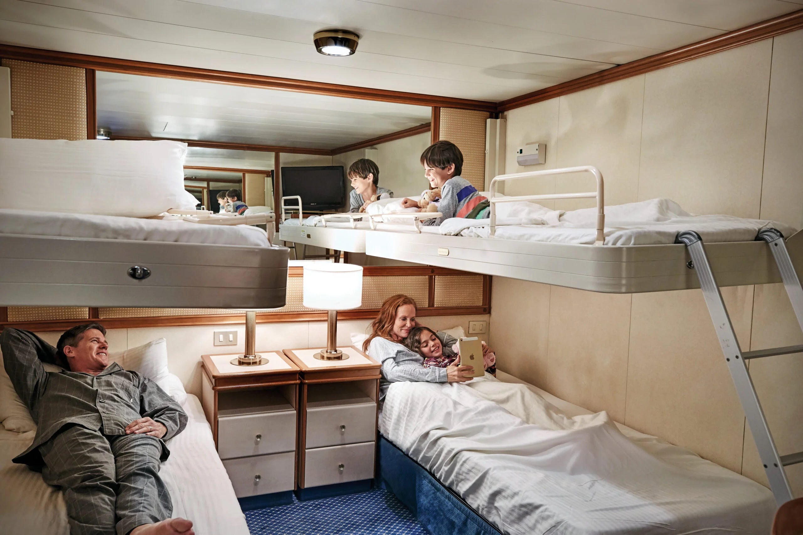 Family sharing inside cabin with bunkbeds on a Princess cruise