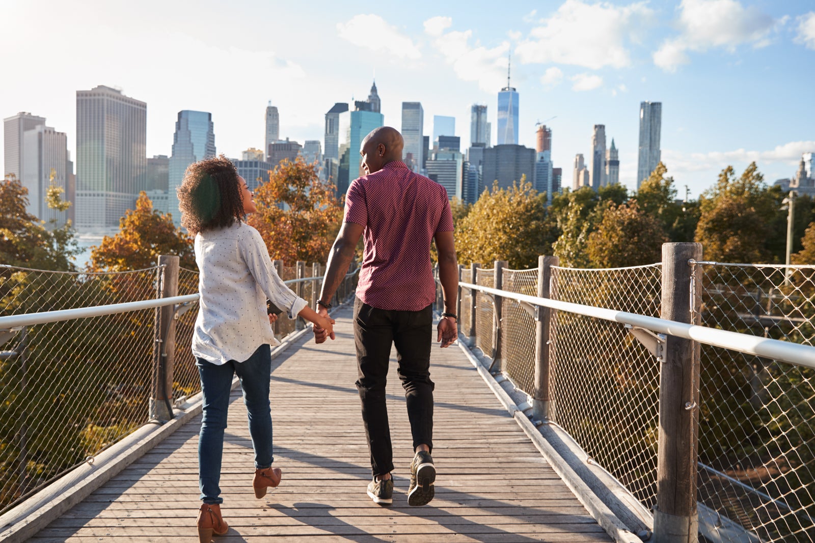 Couple Visiting New York With Manhattan Skyline In Background