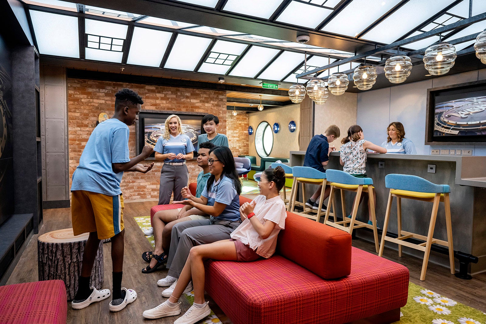 Teen club on Disney cruise with kids playing rock paper scissors