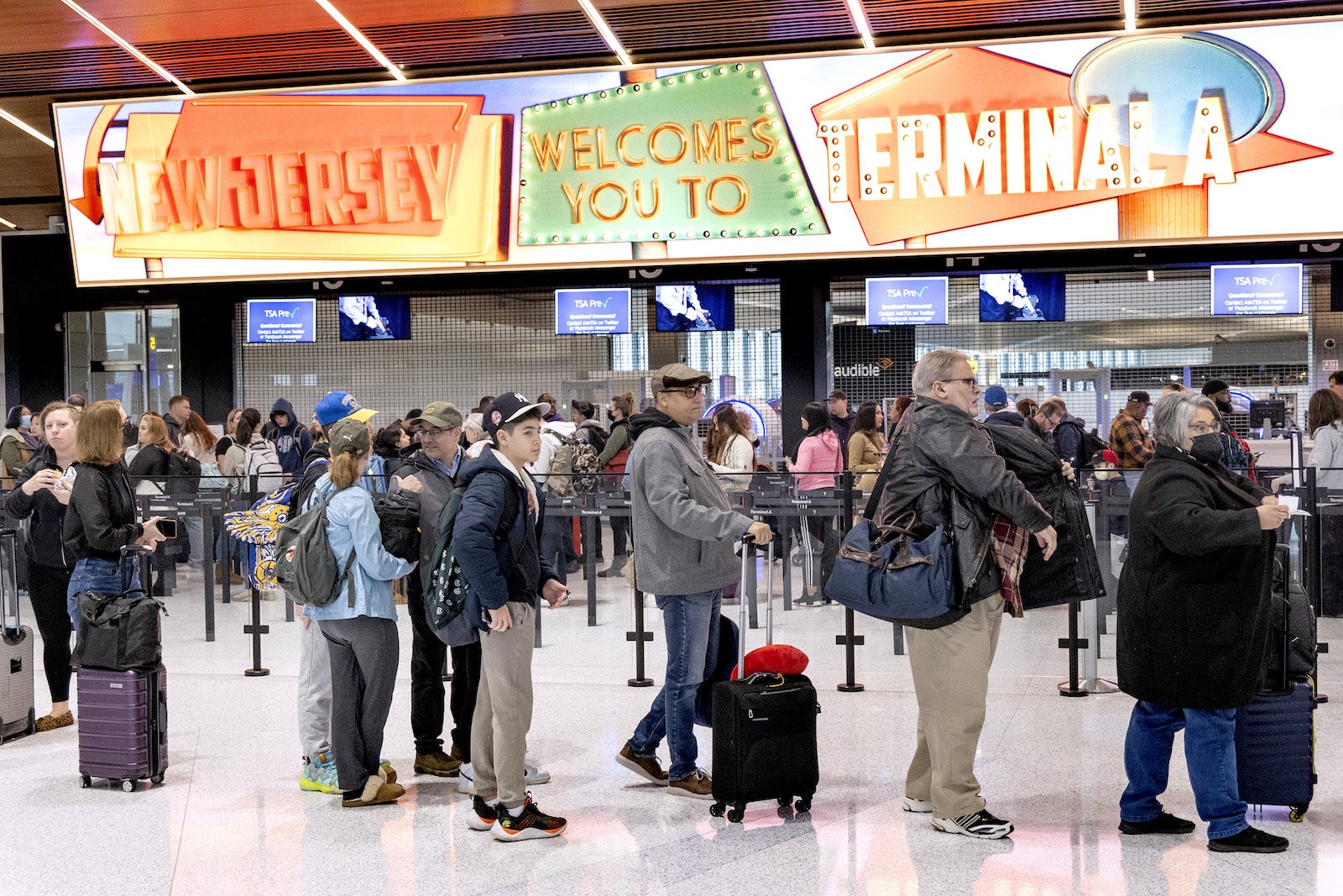 flyers wait in line in an airport