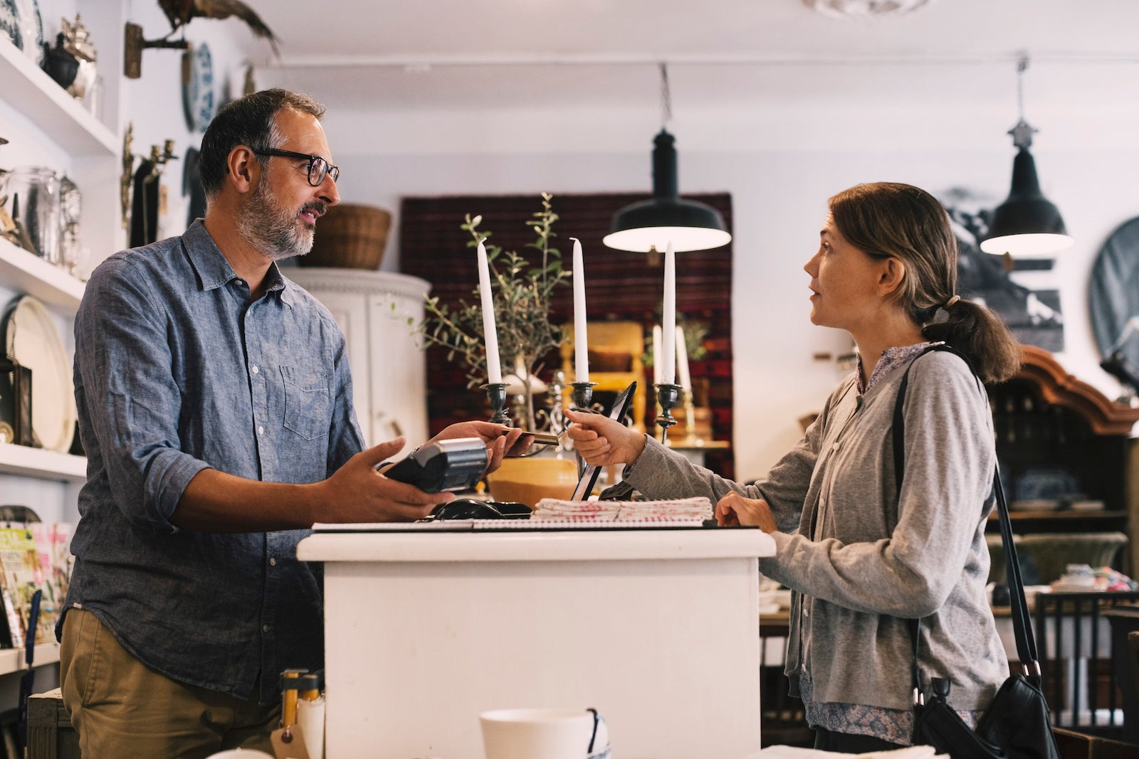 a small business owner talks to a customer