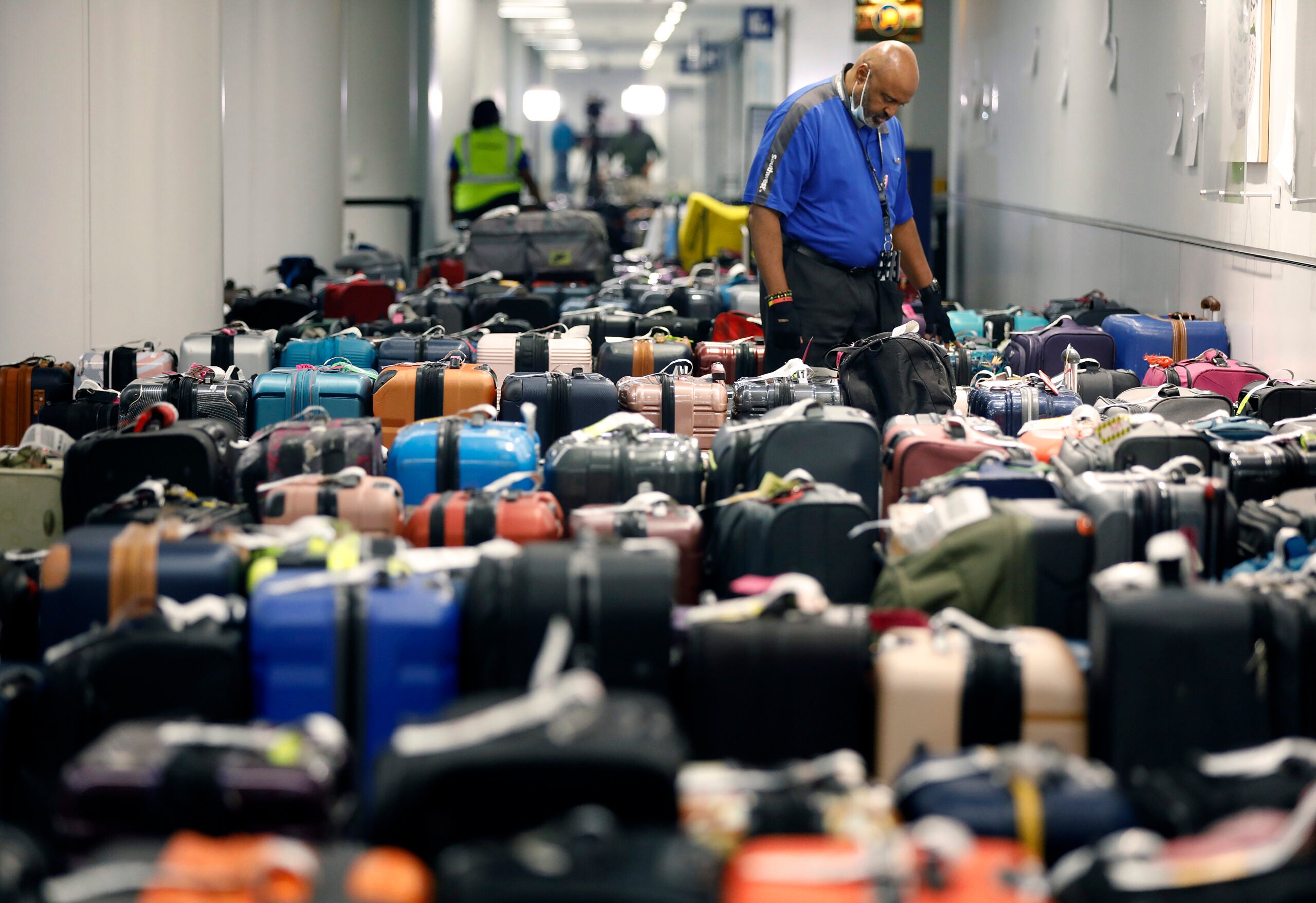 Luggage piles up at an airport