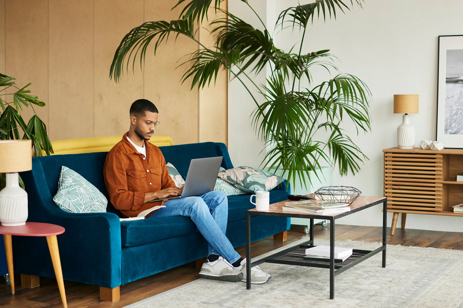 Man using laptop on a couch