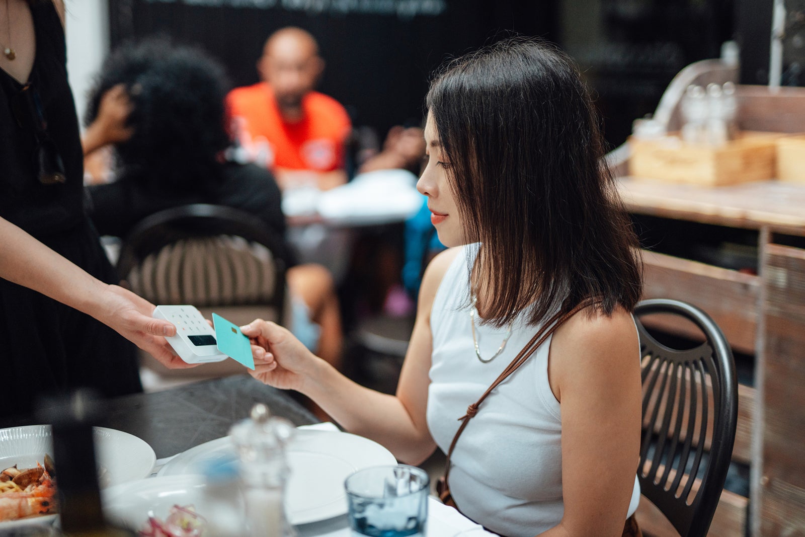 Woman paying for her meal with a credit card