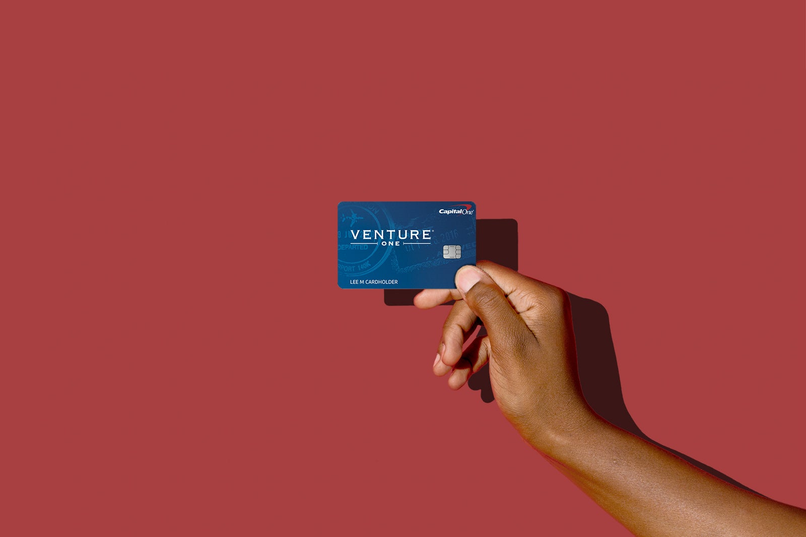 a hand holds a credit card