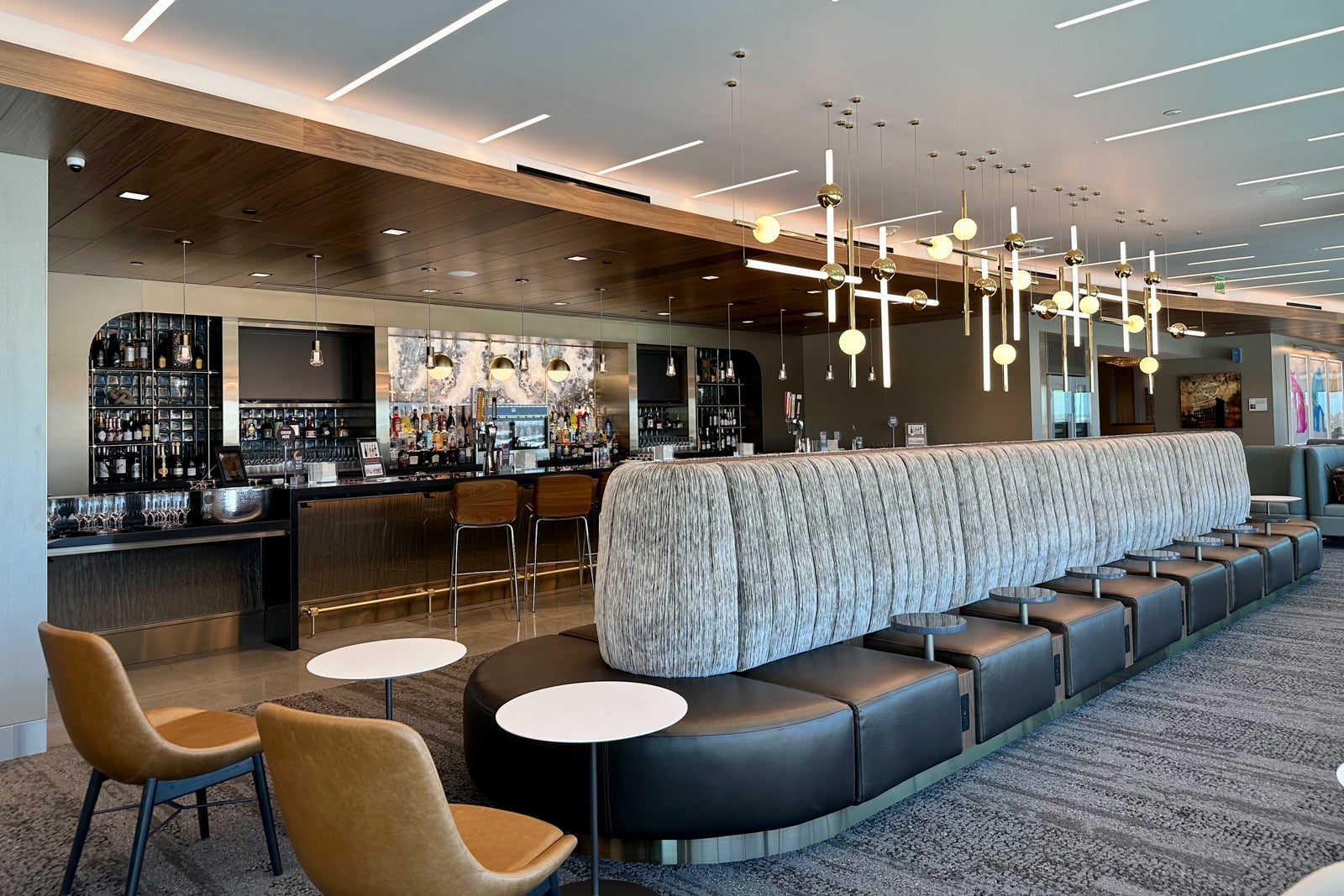 no passengers are visible in this large Delta airport lounge with lots of seating a huge full-service bar, the lounge is ready for grand opening