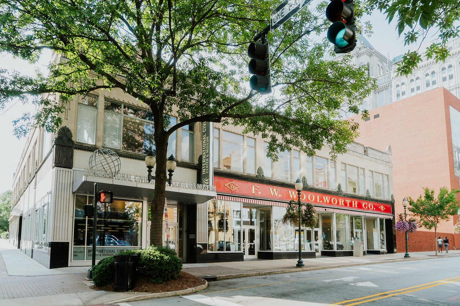 a building with large glass windows and a red F. W. Wooldworth Co. sign