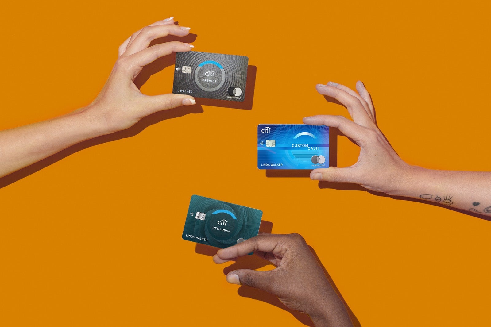 hands hold multiple Citi credit cards