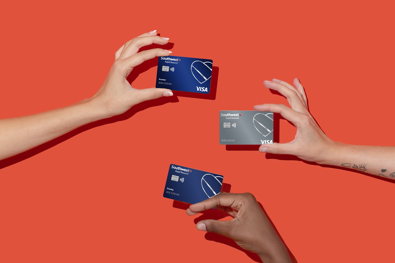 hands hold multiple Southwest Airlines credit cards