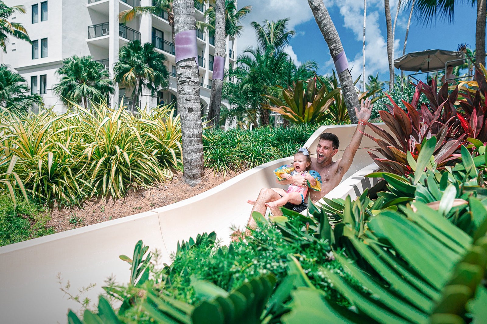 father and daughter on water slide at Wyndham Grand Rio Mar Puerto Rico Golf & Beach Resort