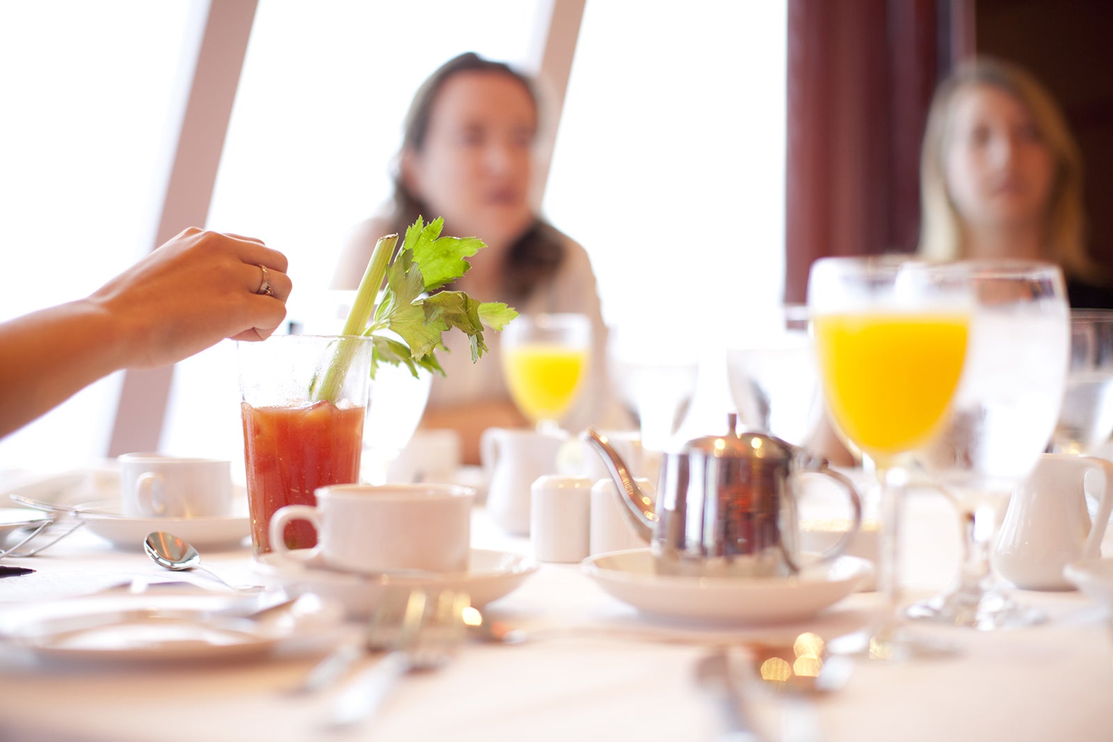 Family eating brunch on cruise ship with orange juice