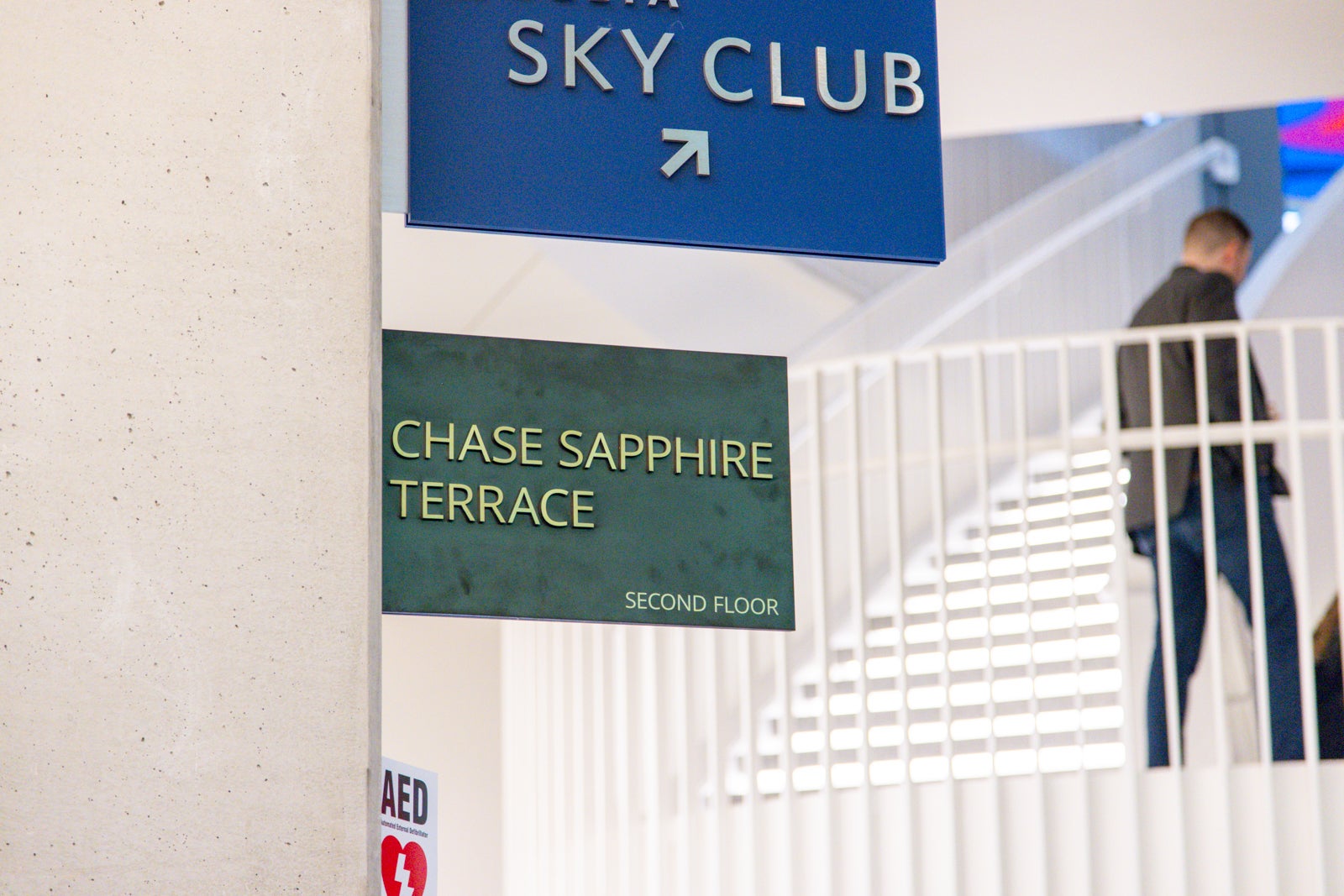 stairs and signs to airport lounges