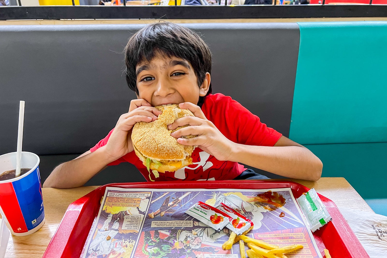 Kid enjoying KFC at airport