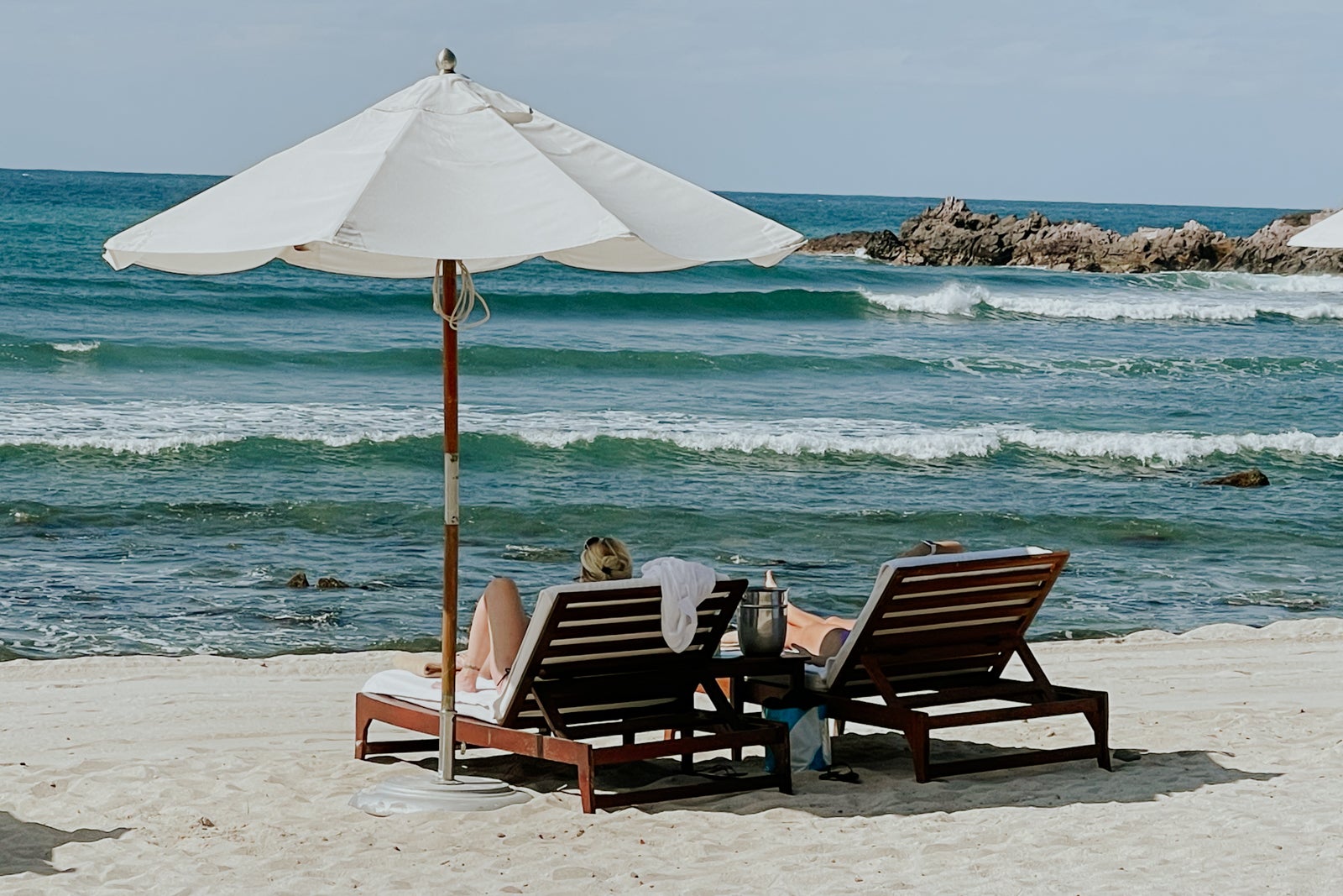 woman lounging on beach at St. Regis Punta Mita