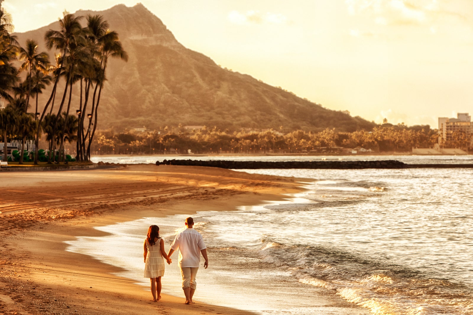 Happy Couple Walking on Waikiki Beach at Sunrise