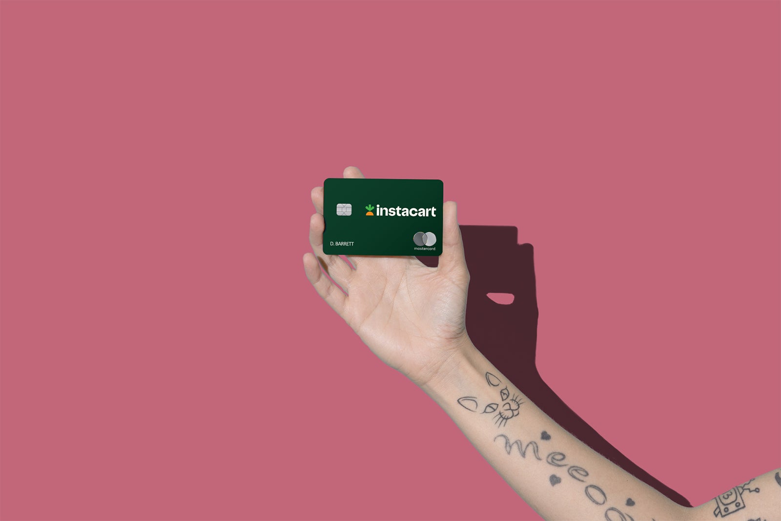 a hand holds the Instacart Mastercard