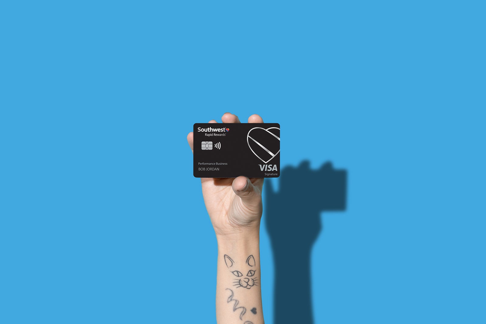 a hand holds a credit card