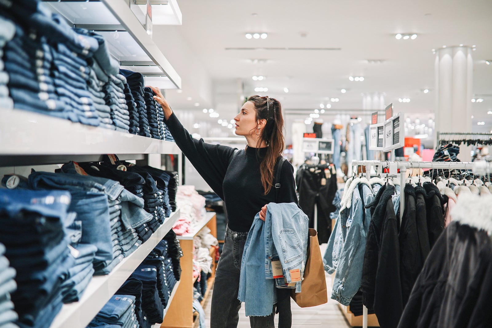 woman shopping denim jeans in a clothing store