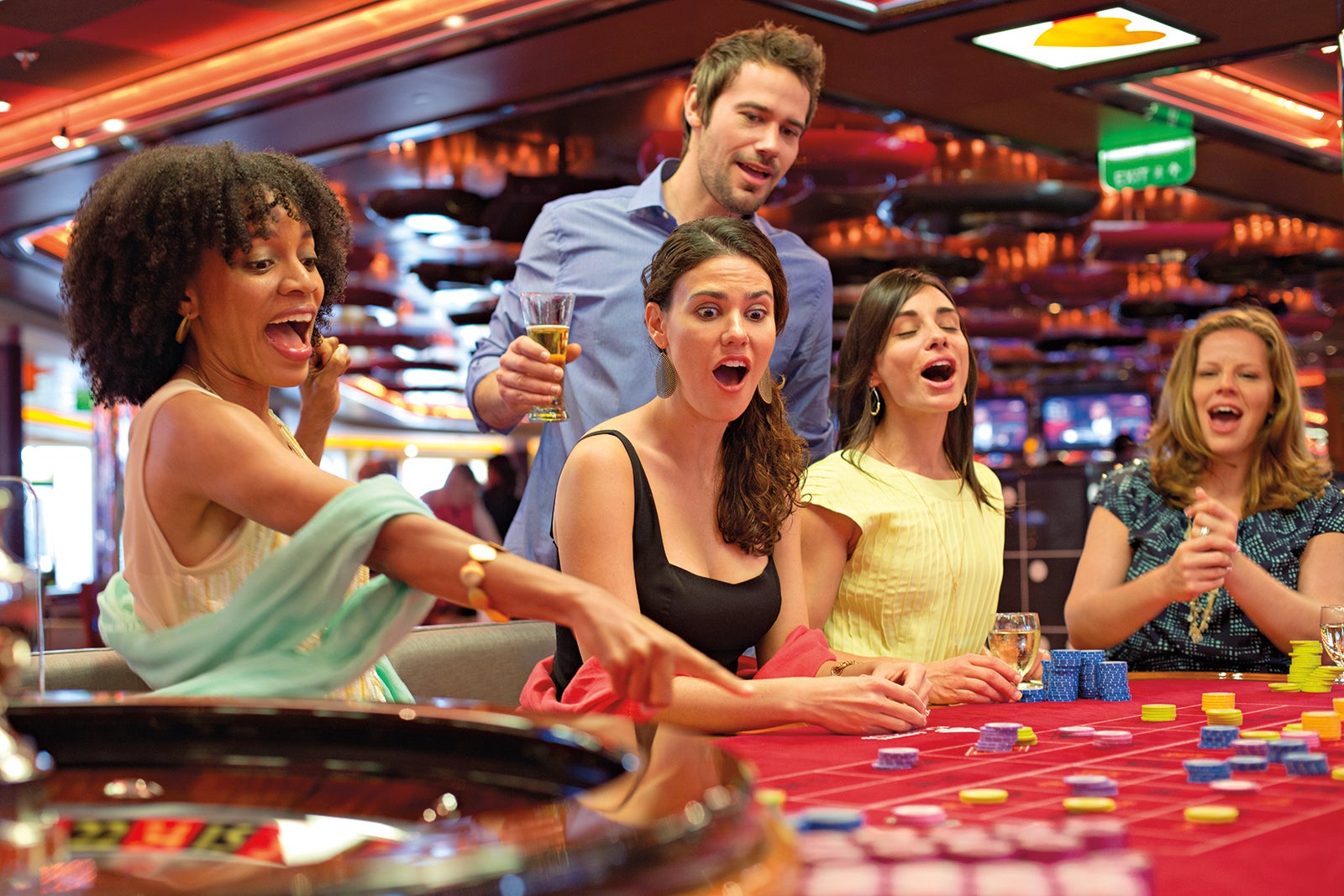 Excited group of friends in casino on cruise ship