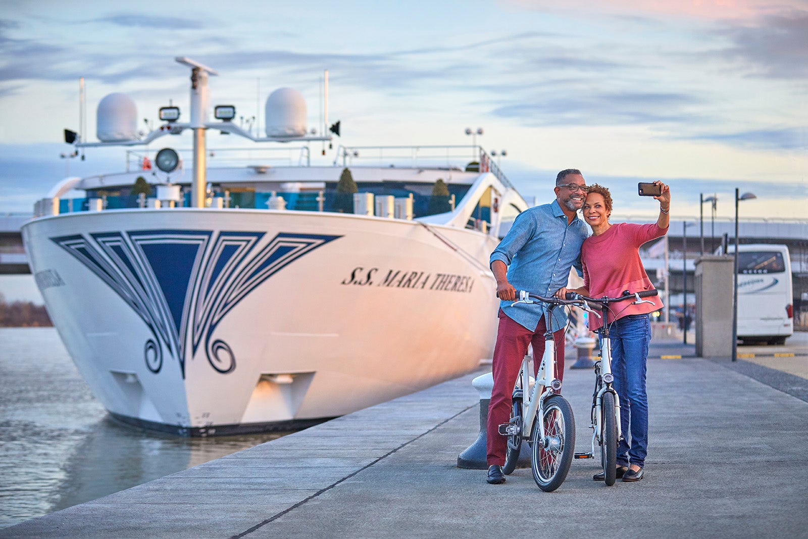 Couple takes selfie in front of river ship in Austria,.