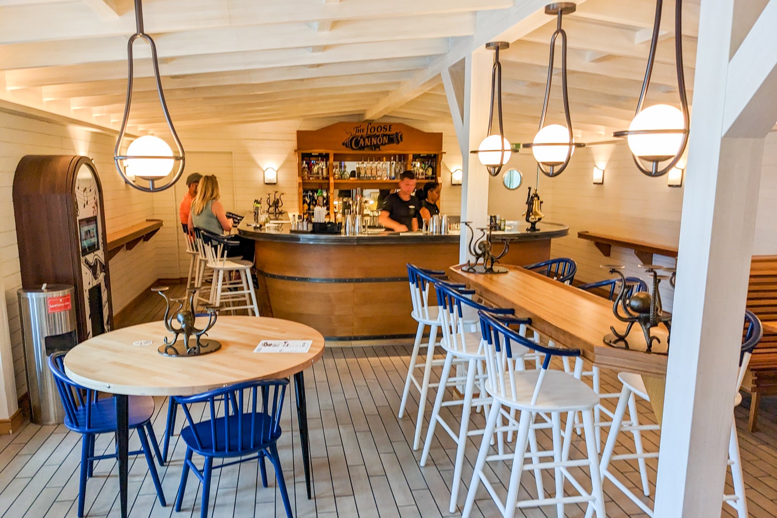 Nautical themed bar with two people sitting at bar counter
