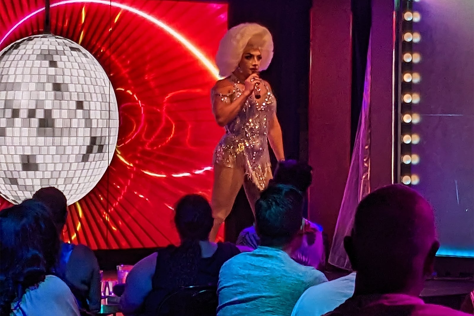 Blonde drag queen on stage in sparkly dress