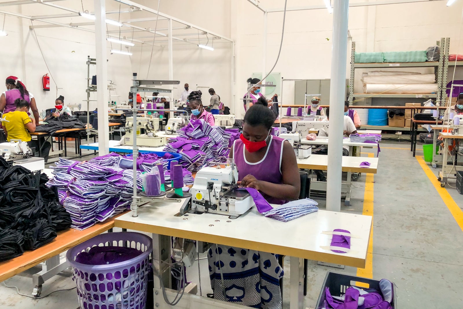 Workers make female reproductive health kits at Huru International.