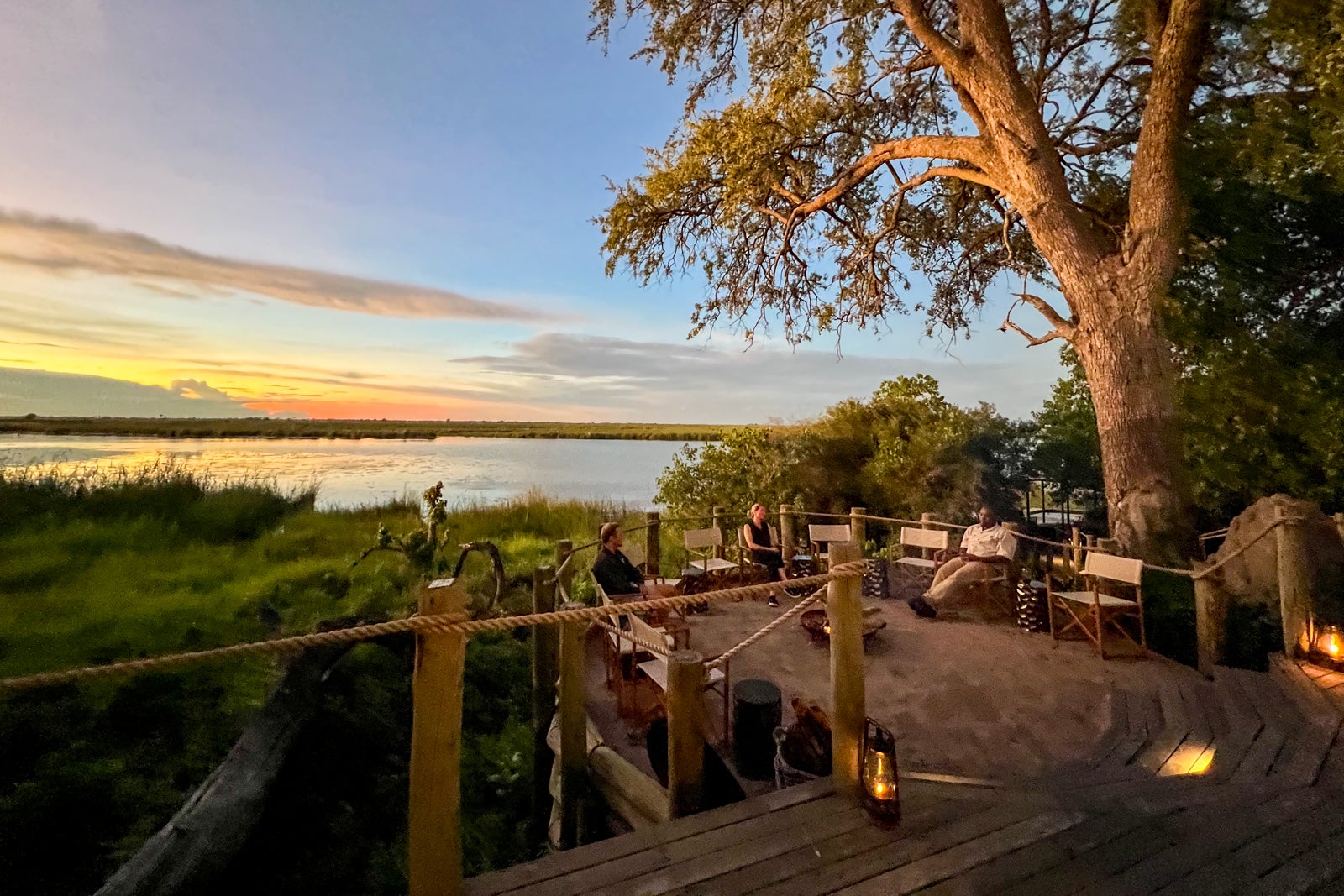 Safari-goers sit around a bonfire at Little DumaTau.